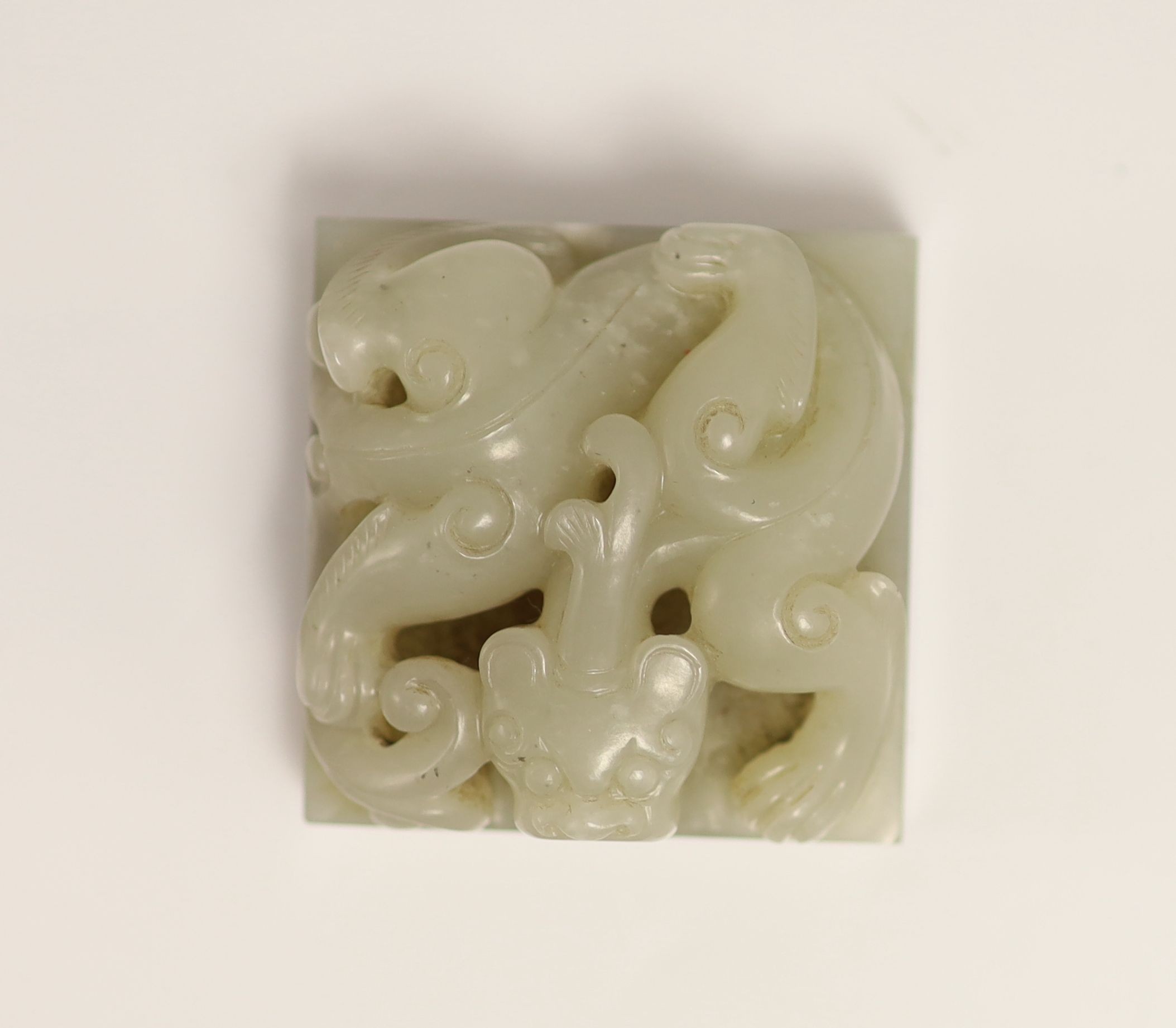 A Chinese pale grey jade ‘chilong’ seal, 5cm square